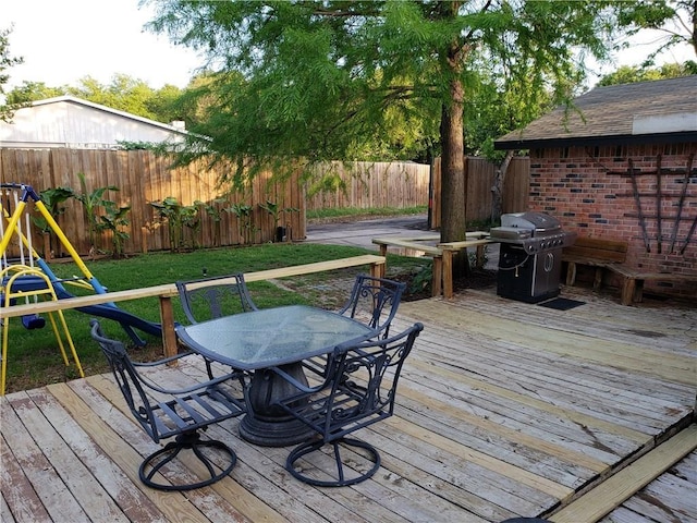3102 Chestnut Rd, Carrollton, TX 75007 - wooden deck featuring a grill, outdoor dining space, and a playground