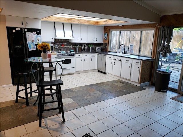 3102 Chestnut Rd, Carrollton, TX 75007 - kitchen featuring white electric stove, dishwasher, black fridge, a sink, and dark countertops