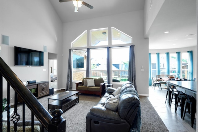 2806 Palmerston Dr, Midlothian, TX 76065 - living area with high vaulted ceiling, ceiling fan, baseboards, tile patterned flooring, and stairway