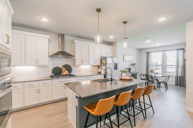 14709 Storyteller Ln, Fort Worth, TX 76052 - kitchen with wall chimney range hood, a sink, gas stovetop, decorative backsplash, and white cabinetry