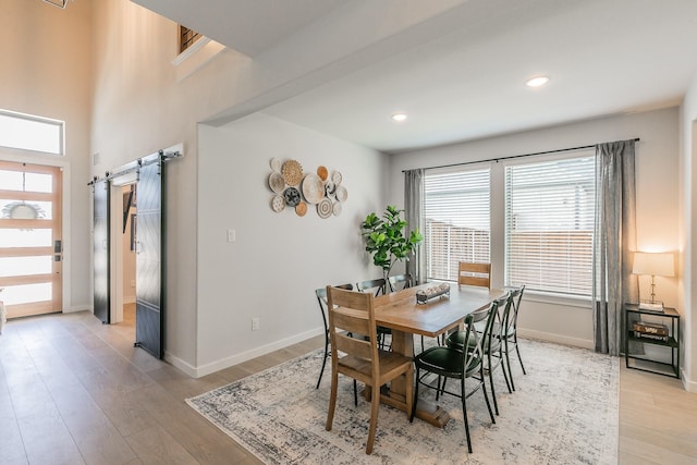 14709 Storyteller Ln, Fort Worth, TX 76052 - dining area featuring a barn door, light wood-style flooring, baseboards, and recessed lighting