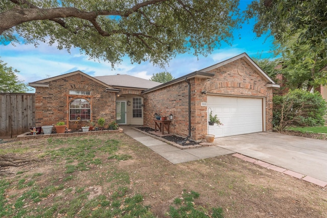 1053 Pullman Dr, Saginaw, TX 76131 - view of front of home with a garage, driveway, and brick siding
