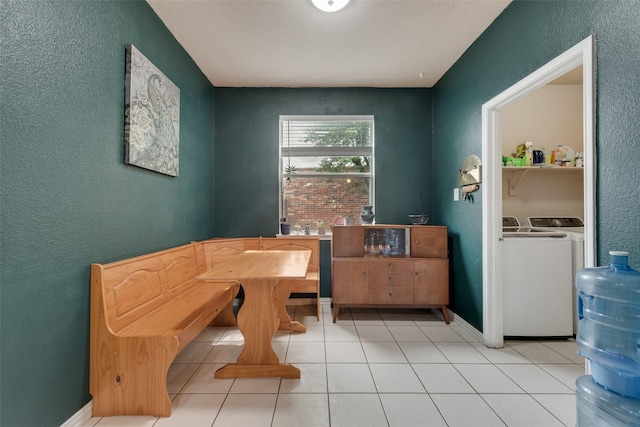1053 Pullman Dr, Saginaw, TX 76131 - dining space featuring separate washer and dryer, a textured wall, light tile patterned floors, and baseboards