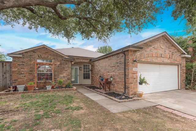 1053 Pullman Dr, Saginaw, TX 76131 - ranch-style house with a garage, driveway, and brick siding