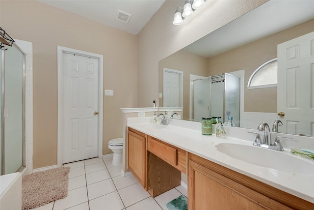 1053 Pullman Dr, Saginaw, TX 76131 - bathroom featuring a stall shower, toilet, double vanity, and tile patterned flooring