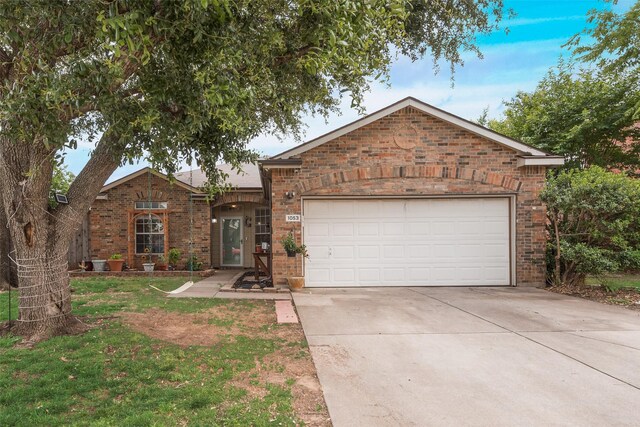 1053 Pullman Dr, Saginaw, TX 76131 - ranch-style house with driveway, brick siding, an attached garage, and a front lawn