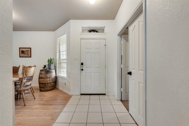 1053 Pullman Dr, Saginaw, TX 76131 - foyer entrance featuring light wood-style floors, baseboards, and a textured wall