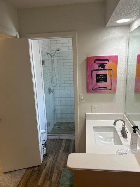 3624 Aurora St, Haltom City, TX 76117 - bathroom with a stall shower, vanity, and wood finished floors