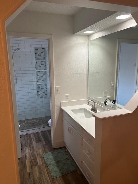 3624 Aurora St, Haltom City, TX 76117 - full bath featuring wood finished floors, a shower stall, vanity, and toilet