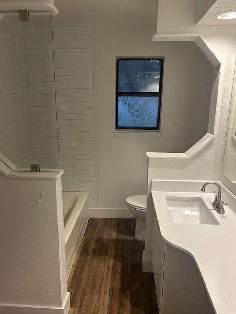 3624 Aurora St, Haltom City, TX 76117 - full bathroom with vanity, wood finished floors, toilet, baseboards, and tub / shower combination