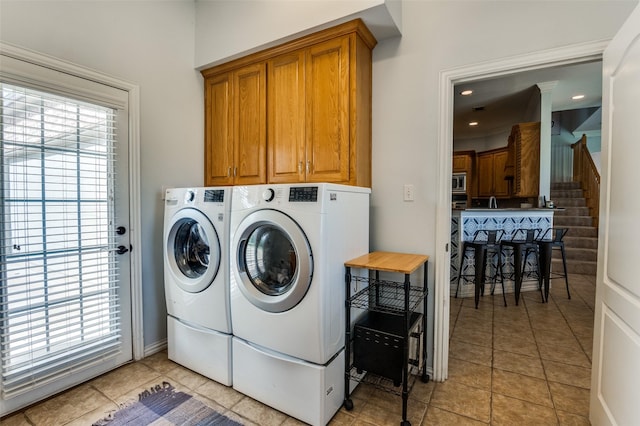 336 Maggie St, Canton, TX 75103 - laundry area featuring washer and clothes dryer, cabinet space, and light tile patterned flooring