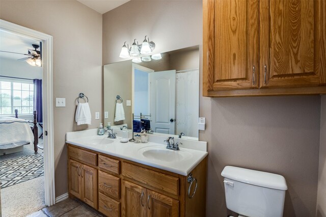 336 Maggie St, Canton, TX 75103 - ensuite bathroom with a ceiling fan, double vanity, toilet, and tile patterned floors