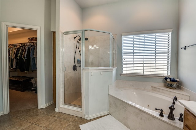 336 Maggie St, Canton, TX 75103 - bathroom featuring a shower stall, a whirlpool tub, tile patterned flooring, and a walk in closet