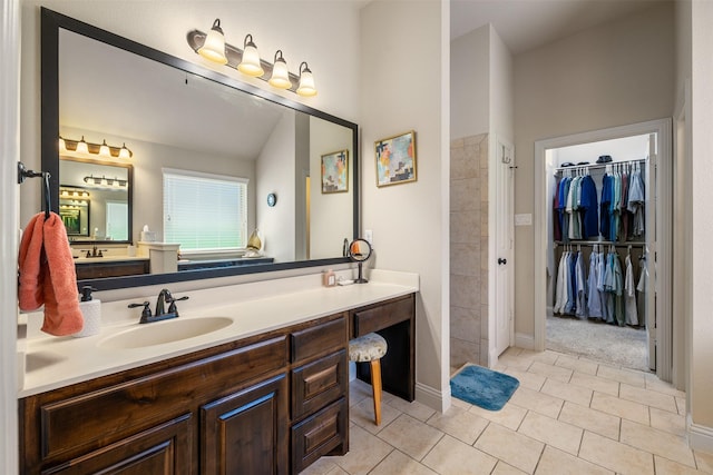 217 Golden Arrow Dr, Weatherford, TX 76087 - bathroom with vanity, tile patterned floors, and a walk in closet