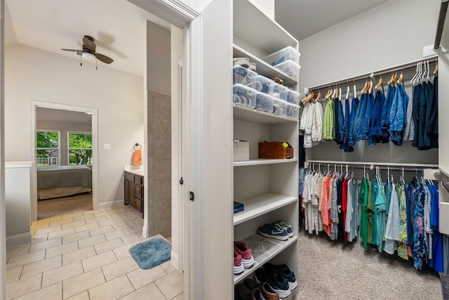 217 Golden Arrow Dr, Weatherford, TX 76087 - walk in closet featuring a ceiling fan, lofted ceiling, tile patterned floors, and carpet flooring