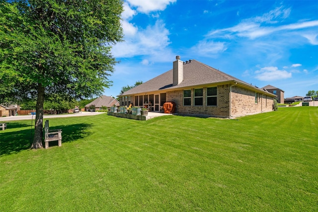 217 Golden Arrow Dr, Weatherford, TX 76087 - back of house featuring a lawn, brick siding, and a chimney