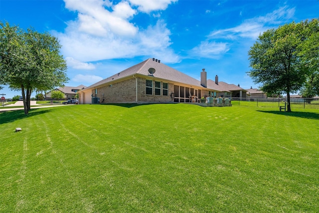217 Golden Arrow Dr, Weatherford, TX 76087 - back of property with brick siding, a sunroom, and cooling unit