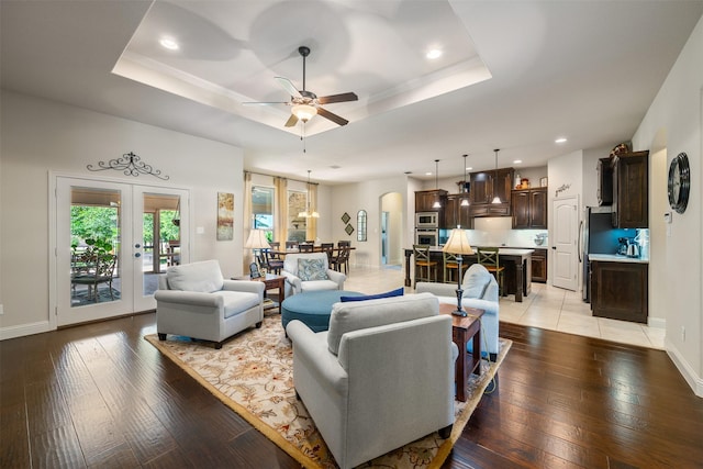 217 Golden Arrow Dr, Weatherford, TX 76087 - living room with a raised ceiling, light wood-style floors, ceiling fan, recessed lighting, and baseboards