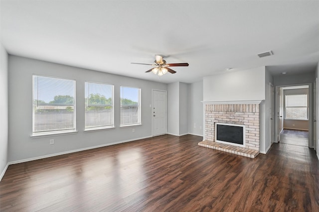2712 Murphy Dr, Lancaster, TX 75134 - unfurnished living room featuring ceiling fan, dark wood-style flooring, a fireplace, and baseboards