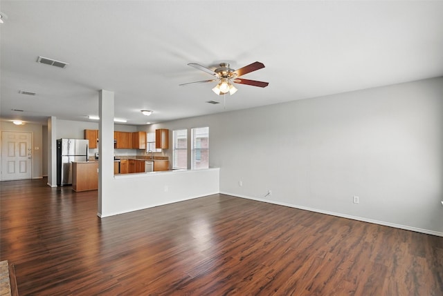 2712 Murphy Dr, Lancaster, TX 75134 - unfurnished living room with a ceiling fan, dark wood-style floors, and baseboards