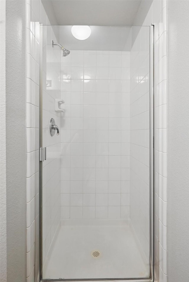 2712 Murphy Dr, Lancaster, TX 75134 - bathroom featuring a shower stall and a textured wall