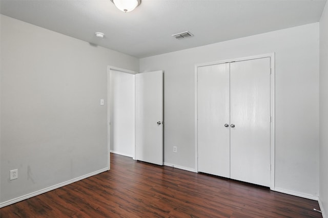 2712 Murphy Dr, Lancaster, TX 75134 - unfurnished bedroom with dark wood-type flooring, a closet, and baseboards