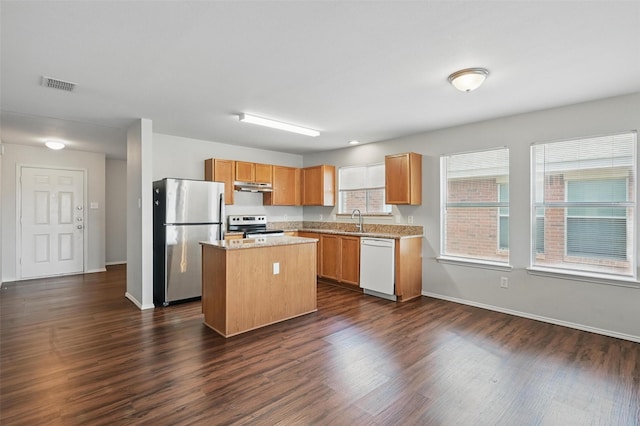 2712 Murphy Dr, Lancaster, TX 75134 - kitchen with stainless steel appliances, a center island, dark wood-type flooring, under cabinet range hood, and baseboards