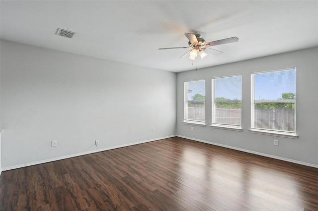 2712 Murphy Dr, Lancaster, TX 75134 - spare room with ceiling fan, dark wood-style floors, and baseboards