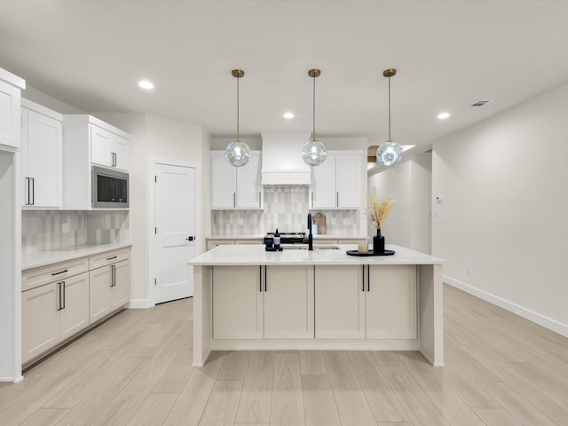 2207 Irion Ave, Fort Worth, TX 76106 - kitchen with stainless steel microwave, a sink, light countertops, backsplash, and recessed lighting
