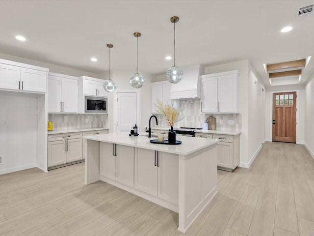 2207 Irion Ave, Fort Worth, TX 76106 - kitchen with stainless steel appliances, white cabinetry, decorative backsplash, light countertops, and recessed lighting