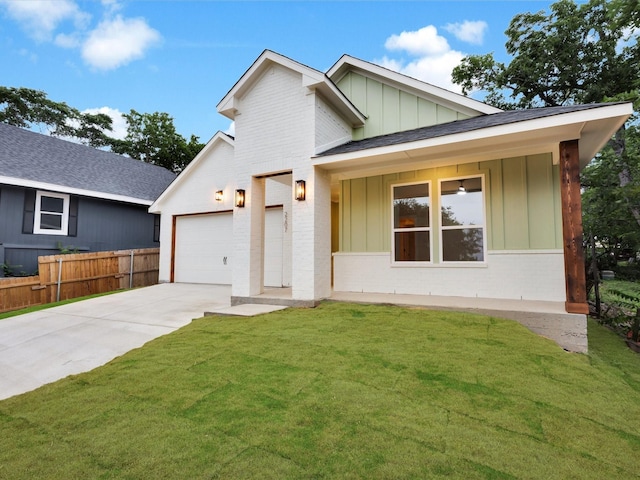 2207 Irion Ave, Fort Worth, TX 76106 - view of front of property featuring board and batten siding, concrete driveway, an attached garage, and brick siding