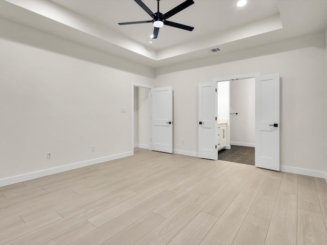 2207 Irion Ave, Fort Worth, TX 76106 - unfurnished bedroom with a tray ceiling, light wood-type flooring, recessed lighting, baseboards, and ceiling fan