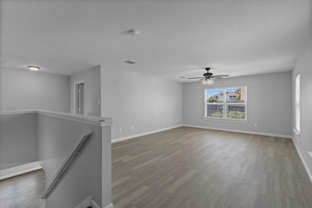 4204 Birch Creek Rd, Fort Worth, TX 76244 - empty room with wood finished floors, baseboards, a ceiling fan, a textured ceiling, and a smoke detector