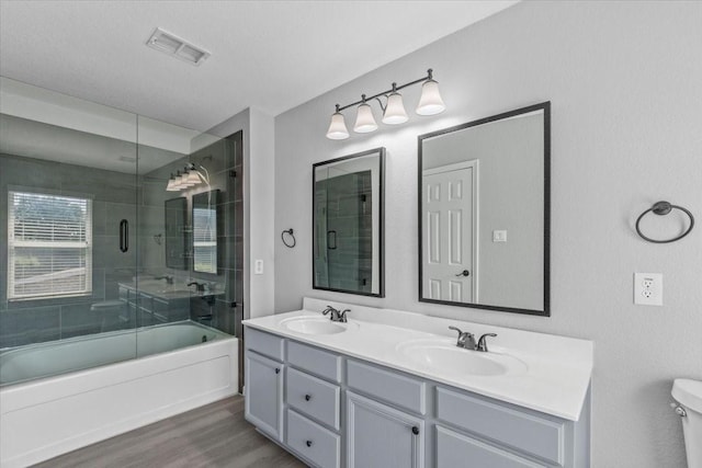 4204 Birch Creek Rd, Fort Worth, TX 76244 - bathroom with wood finished floors, double vanity, combined bath / shower with glass door, and toilet