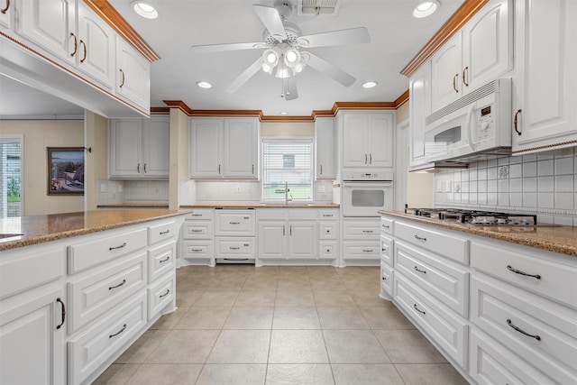 120 Wooded Crest Dr, Woodway, TX 76712 - kitchen featuring white appliances, a ceiling fan, backsplash, light stone countertops, and recessed lighting