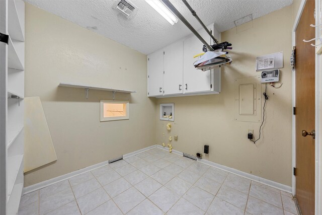 120 Wooded Crest Dr, Woodway, TX 76712 - washroom with cabinet space, a textured ceiling, hookup for a washing machine, gas dryer hookup, and electric panel