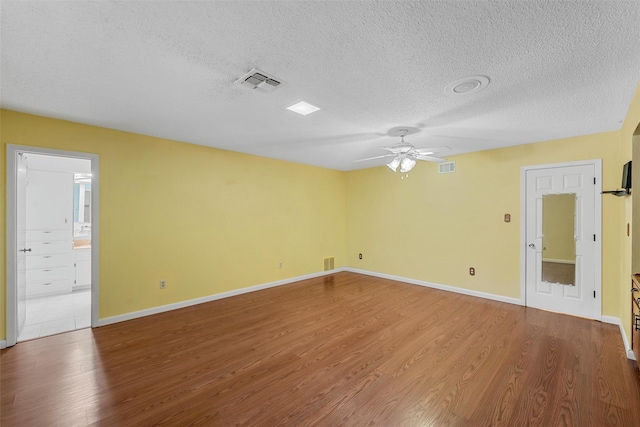 120 Wooded Crest Dr, Woodway, TX 76712 - empty room featuring wood finished floors, a textured ceiling, ceiling fan, and baseboards