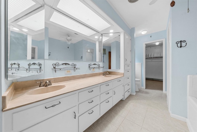 120 Wooded Crest Dr, Woodway, TX 76712 - full bathroom with ceiling fan, double vanity, toilet, tile patterned flooring, and a walk in closet