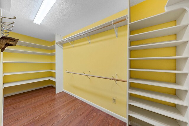120 Wooded Crest Dr, Woodway, TX 76712 - walk in closet featuring wood finished floors