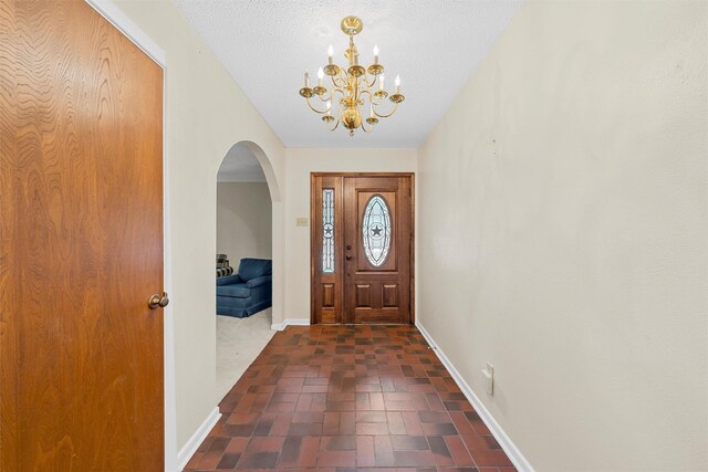 120 Wooded Crest Dr, Woodway, TX 76712 - foyer with baseboards, a chandelier, and arched walkways