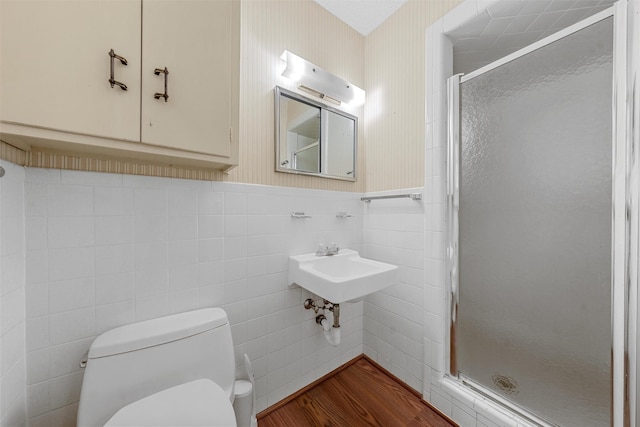 120 Wooded Crest Dr, Woodway, TX 76712 - full bath featuring toilet, a shower stall, tile walls, wood finished floors, and wainscoting