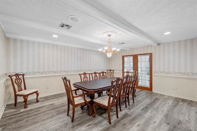 120 Wooded Crest Dr, Woodway, TX 76712 - dining room with wood finished floors, wallpapered walls, a textured ceiling, a wainscoted wall, and beam ceiling