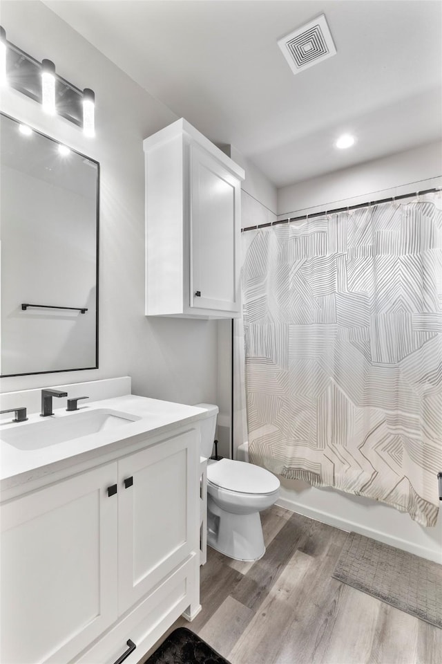 4518 Velta Ln, Abilene, TX 79606 - full bathroom featuring vanity, wood finished floors, toilet, and recessed lighting