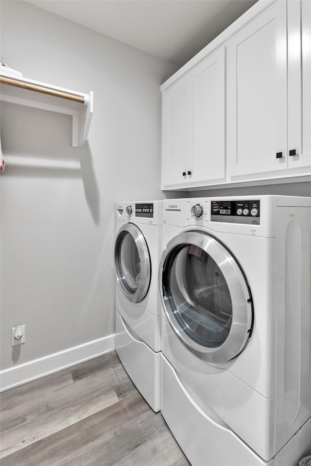 4518 Velta Ln, Abilene, TX 79606 - laundry room with separate washer and dryer, cabinet space, light wood-style flooring, and baseboards