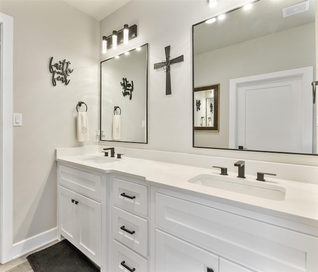 4518 Velta Ln, Abilene, TX 79606 - full bath featuring double vanity, wood finished floors, and baseboards