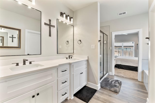 4518 Velta Ln, Abilene, TX 79606 - full bathroom featuring double vanity, wood finished floors, a stall shower, connected bathroom, and baseboards