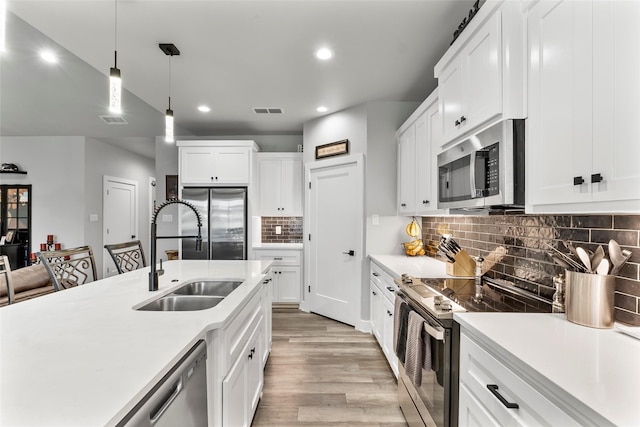 4518 Velta Ln, Abilene, TX 79606 - kitchen with stainless steel appliances, a sink, light wood-style floors, light countertops, and recessed lighting