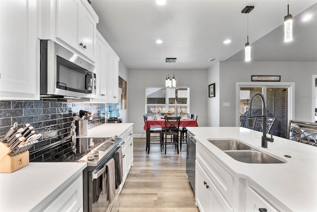 4518 Velta Ln, Abilene, TX 79606 - kitchen featuring appliances with stainless steel finishes, a sink, recessed lighting, light countertops, and tasteful backsplash
