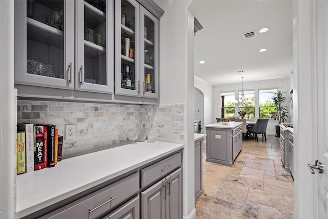 7305 Kingsbarns, The Colony, TX 75056 - bar featuring stone tile flooring, arched walkways, decorative backsplash, and recessed lighting