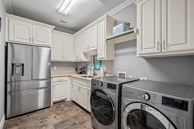 7305 Kingsbarns, The Colony, TX 75056 - laundry area with washer and dryer, stone finish flooring, and cabinet space